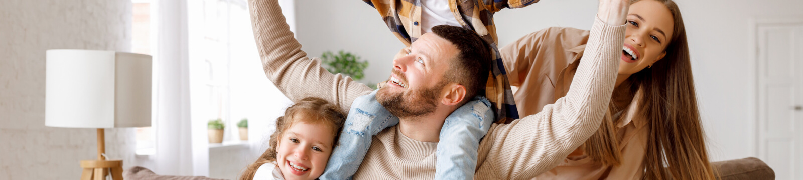 A young family playing together on a couch